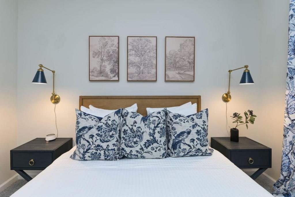 a bedroom with a bed with blue and white pillows at The Augusta Cottage WECO 3Br in West Columbia