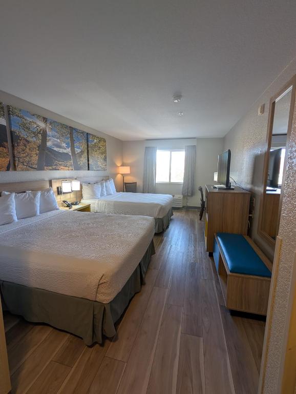 キャッスル・ロックにあるDays Inn & Suites by Wyndham Castle Rockのベッド2台とテレビがあるホテルの部屋