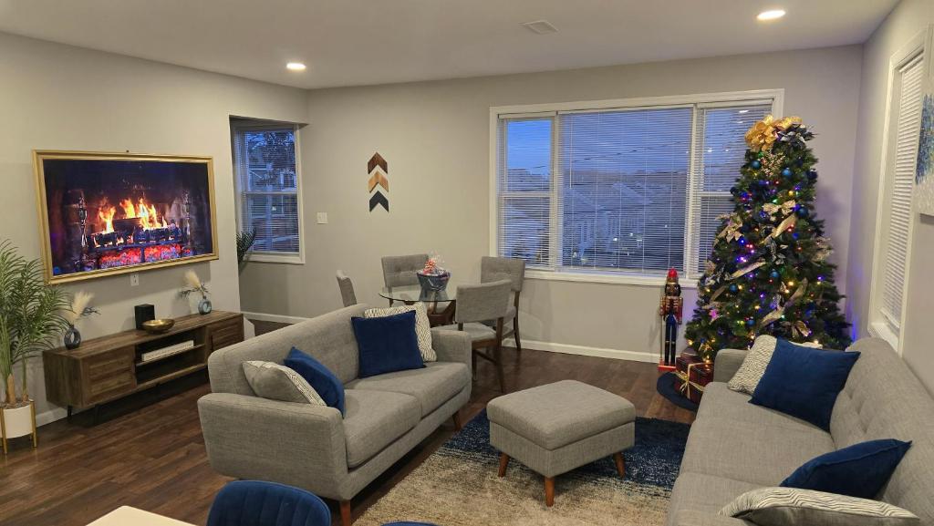 a living room with a christmas tree and a tv at Attractive and Cozy Apartment - 4 bdrms 2 bths in Paterson