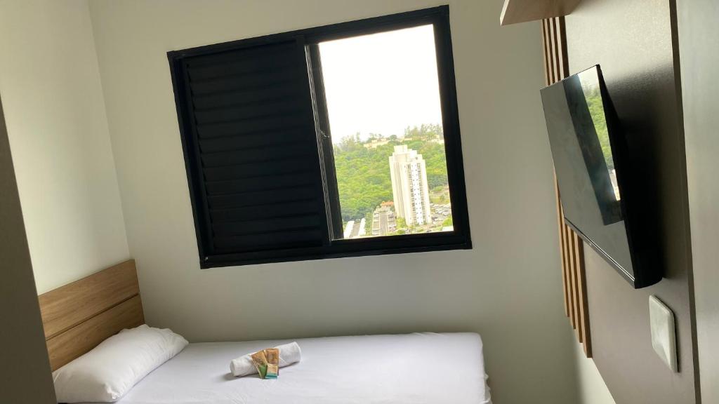 En eller flere senge i et værelse på Apartamento Campinas ao lado Puc 2