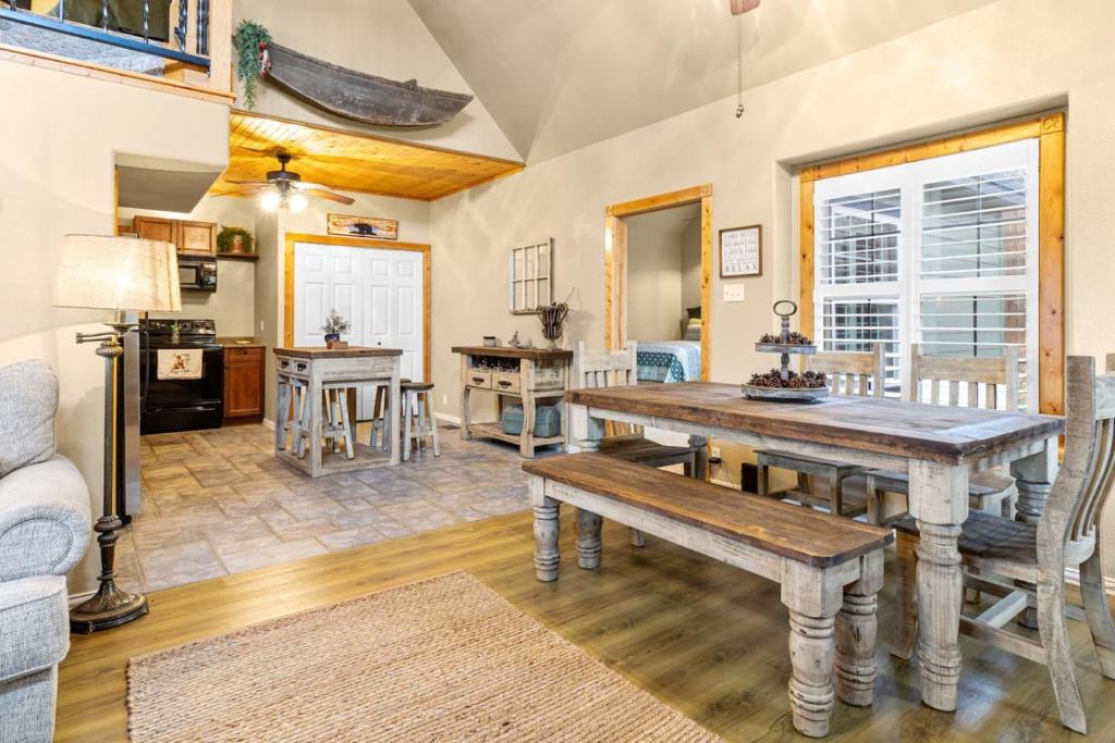 a living room with a wooden table and a couch at Emerald Point, Lakefront with Gorgeous Views in McAlester