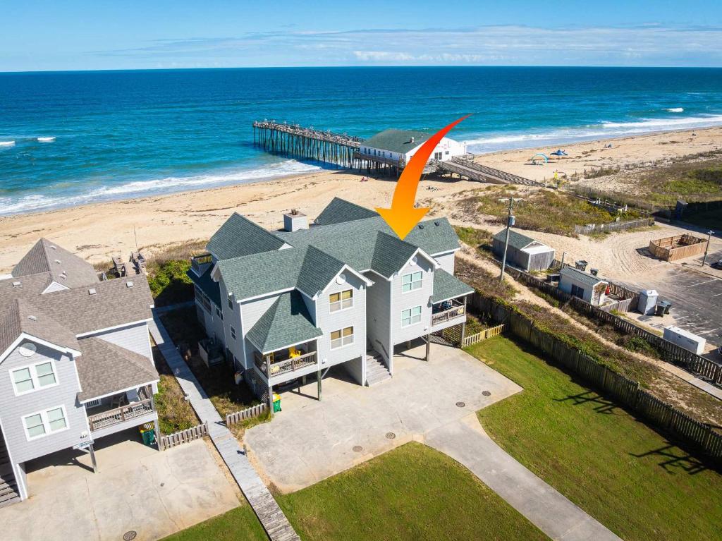 an aerial view of a house and the beach at Oceanfront Private Beach Access & Community Pool in Kitty Hawk Beach