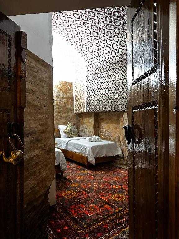 En eller flere senge i et værelse på Mekhtarr Anbar Historical Hotel