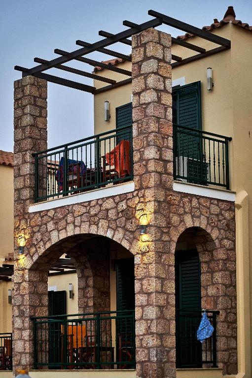 a building with a balcony with two arches at Element Hotel in Elafonisos