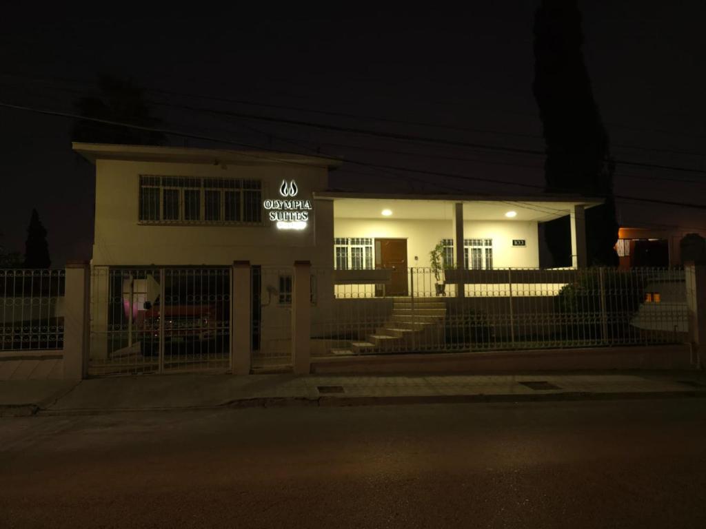 a building with a sign on it at night at Habitación en renta in Saltillo