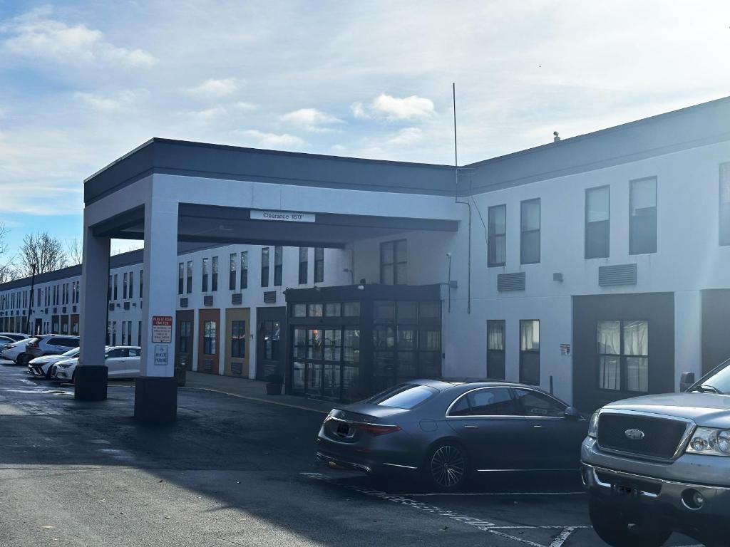 a car parked in a parking lot next to a building at Red Roof Inn & Suites Middleborough in Middleboro