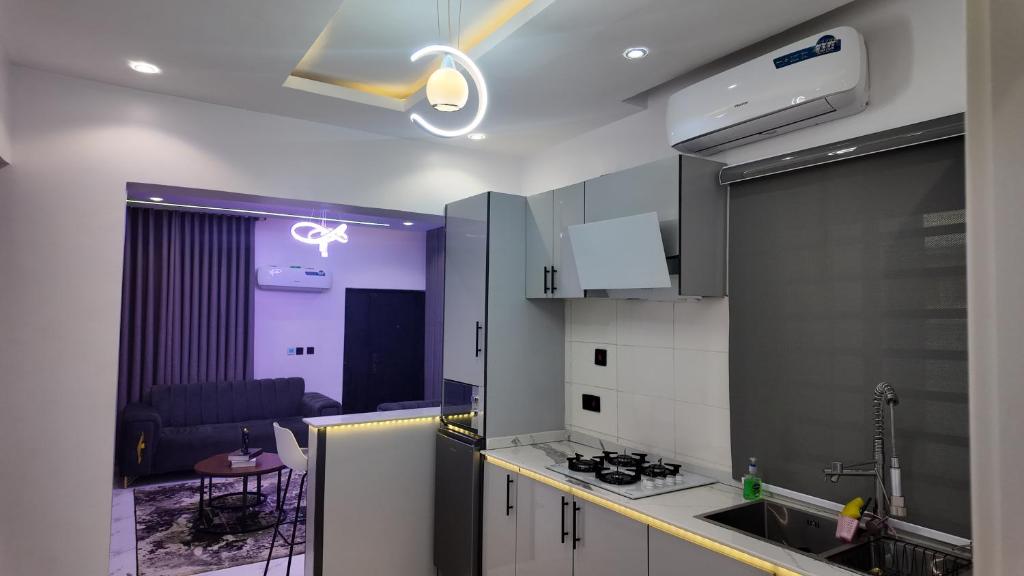 a kitchen with a sink and a stove at White Orchid Inn in Ibadan