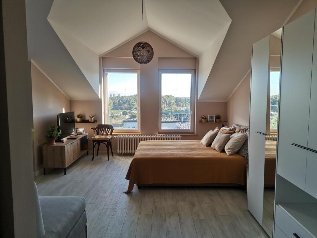 a bedroom with a large bed and a large window at Pogled Ada 1 in Belgrade