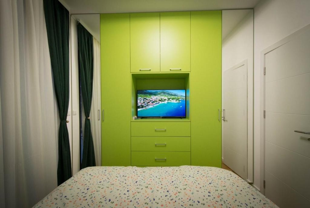 a bedroom with a bed with a tv on it at Prolink Residence Podgorica in Podgorica