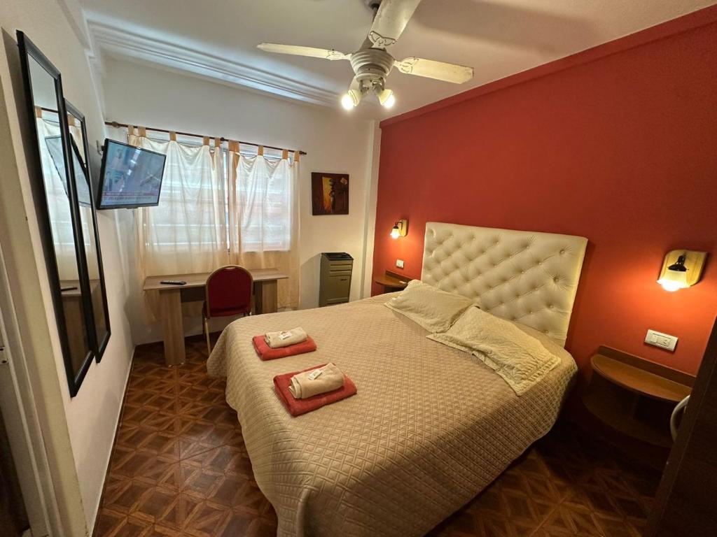 a bedroom with a bed with two towels on it at Apart Sorrento in Santa Teresita