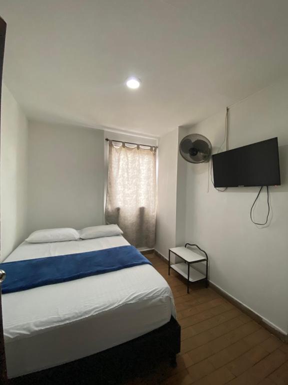 Una cama o camas en una habitación de Hotel el CONDADO