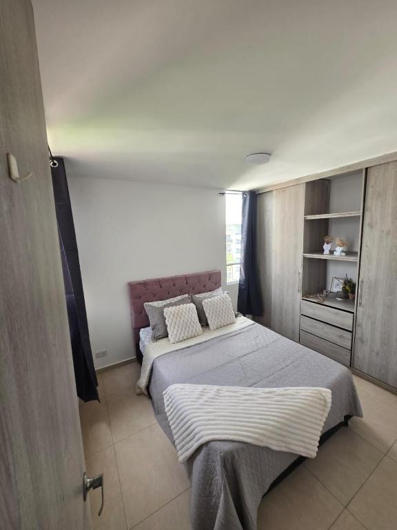 a bedroom with a large bed with two pillows at Luxury five in Villavicencio
