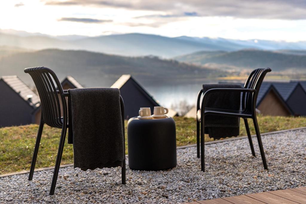 two chairs and a fire hydrant sitting on the ground at Apartament Lake&Hill View w Karkonoszach z możliwym dostępem do strefy WELLNESS w kompleksie in Sosnówka