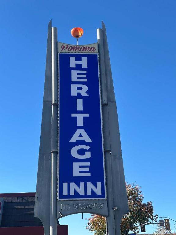 a blue sign for a theatre firm with a ball on top at Heritage Inn in Pomona