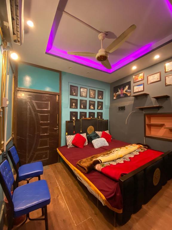 a bedroom with a large bed with purple lighting at Cottage Inn in Faisalabad