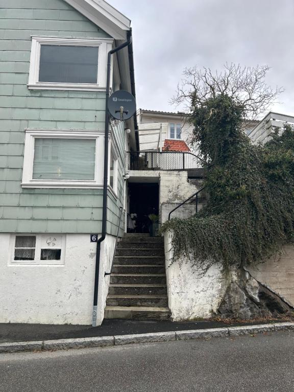 a house with stairs leading up to a door at Cozy top apartment in Egersund city with 3 bedrooms in Egersund