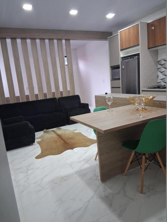 a living room with a table and a couch at Apartamento moderno próximo ao centro in União da Vitória