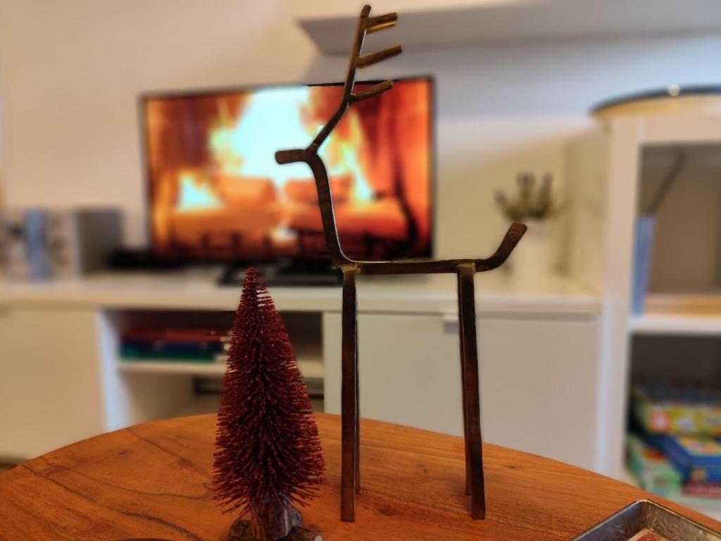 a small pine tree on a table with a tv at O Recuncho de Belén in Baiona