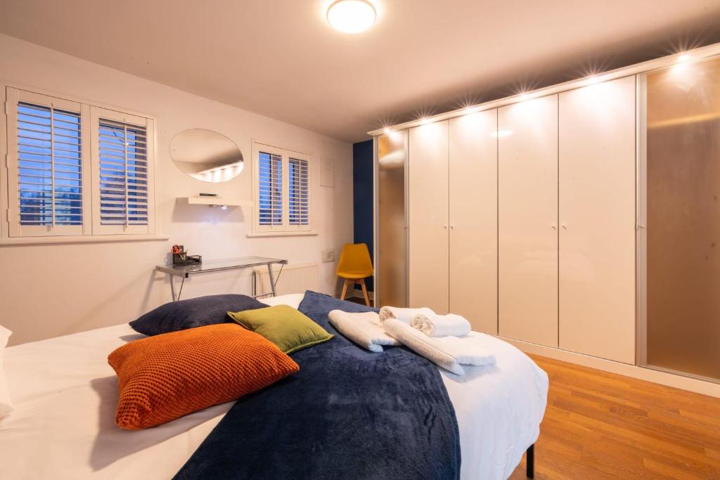 a bedroom with a large bed with pillows on it at Modern 4-bed home Royal Wharf near Excel Canary Wharf London city airport The O2 -Free parking in North Woolwich