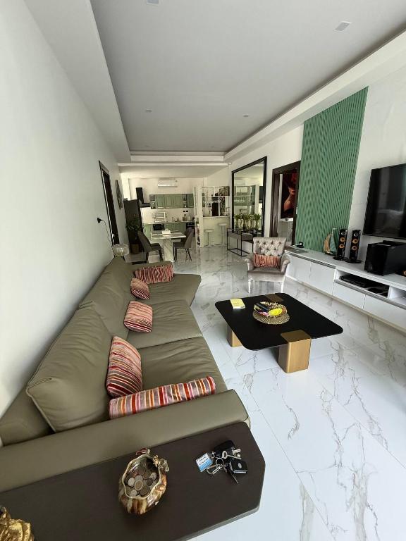 a large living room with a couch and a table at Beautiful villa between jungle in Ban Chong Phli