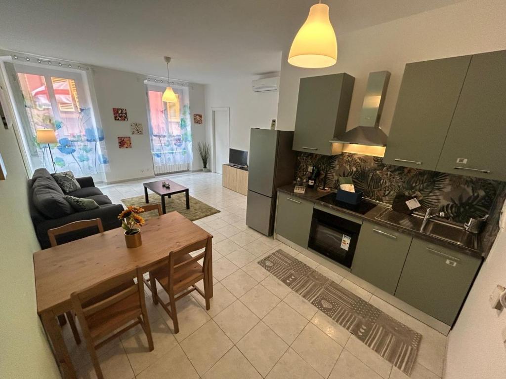 a kitchen and living room with a table and a couch at Il nido di Fra&Gab in Genova