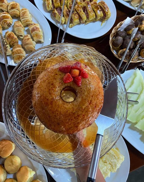 a donut in a basket with strawberries on it at Pousada Três Marias - Guaiuba in Guarujá