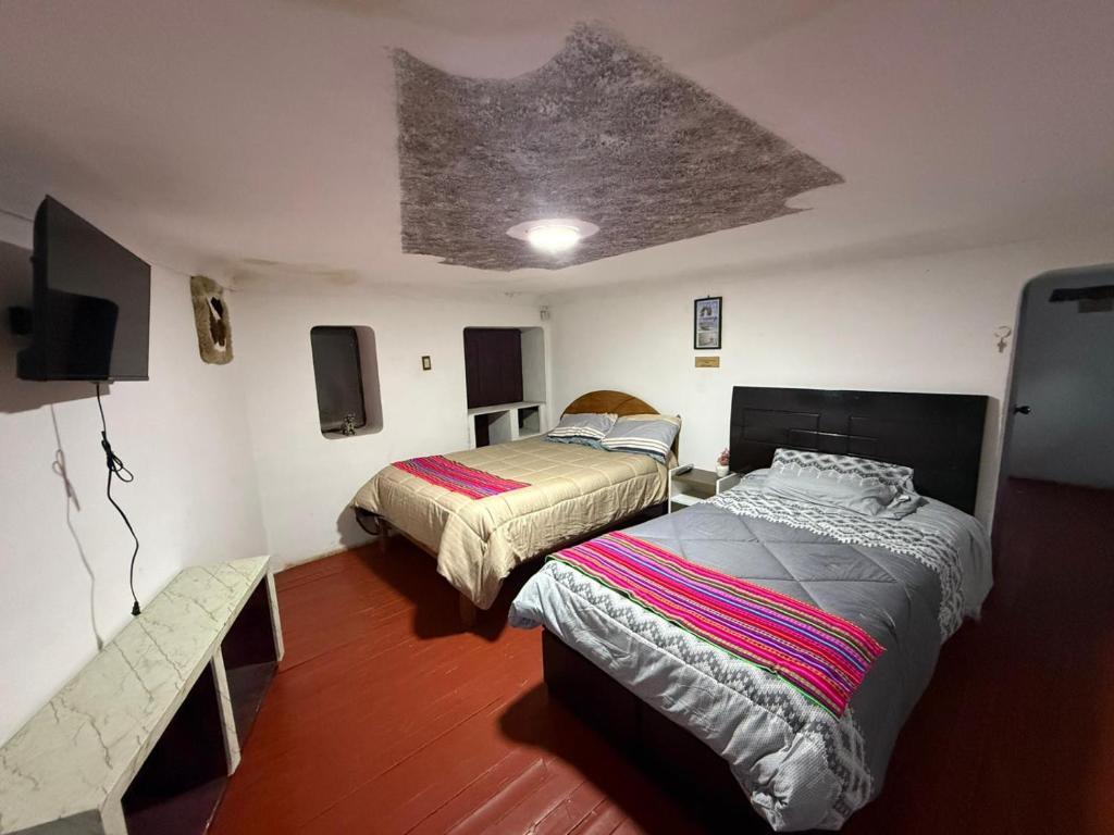 Кровать или кровати в номере QOLLA WASI - Santa Ana