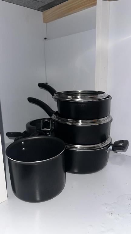 a group of pots and pans sitting on a stove at Cabana da serra in Bueno Brandão