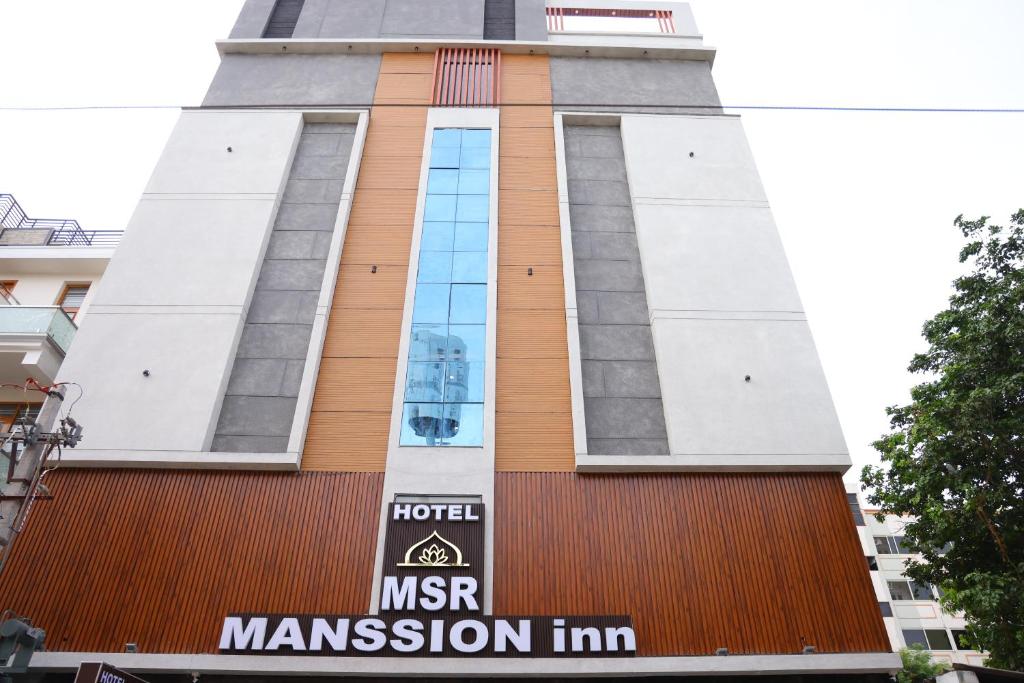 un edificio con un cartello davanti di Hotel Nanda Mohan Residency -MSR Manssion Inn a Tirupati