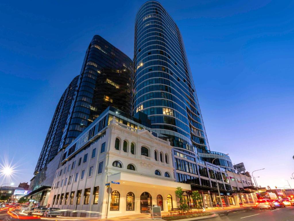 a building in front of some tall buildings at FV by Peppers in Brisbane