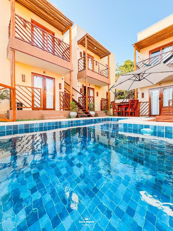 a swimming pool in front of a house at Zaya Beach Residence in Icaraí