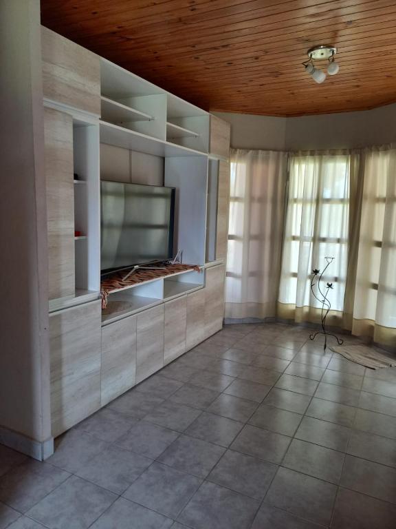 a living room with a fireplace and a wooden ceiling at Alquiler Villa Elisa in Villa Elisa