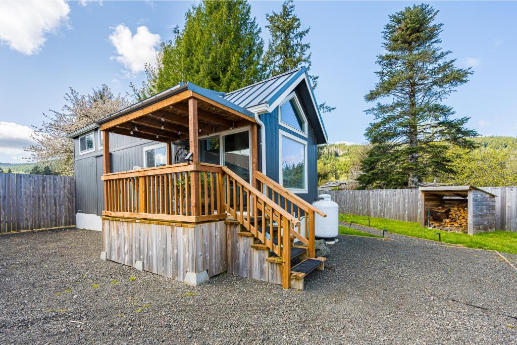 a small house with a wooden porch and a deck at Sol Duc Sanctuary Private & Serene in Forks