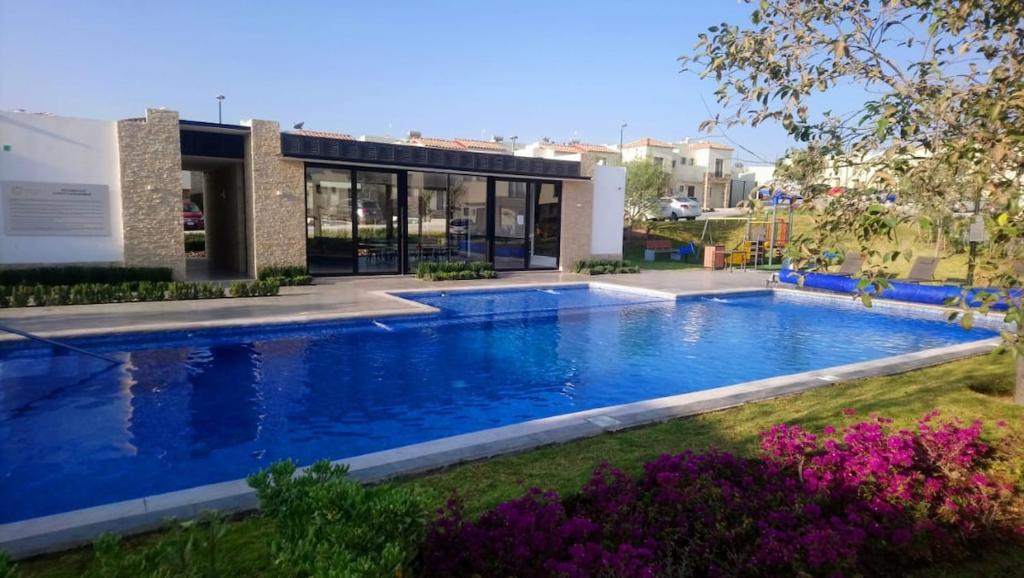 una piscina frente a una casa en House A in a residential condominium with a pool, en Miranda