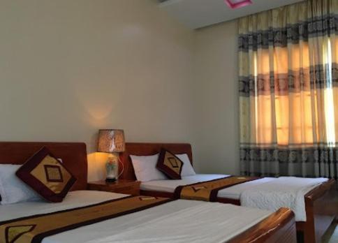 Ένα ή περισσότερα κρεβάτια σε δωμάτιο στο Hải Long Motel Phú Thọ