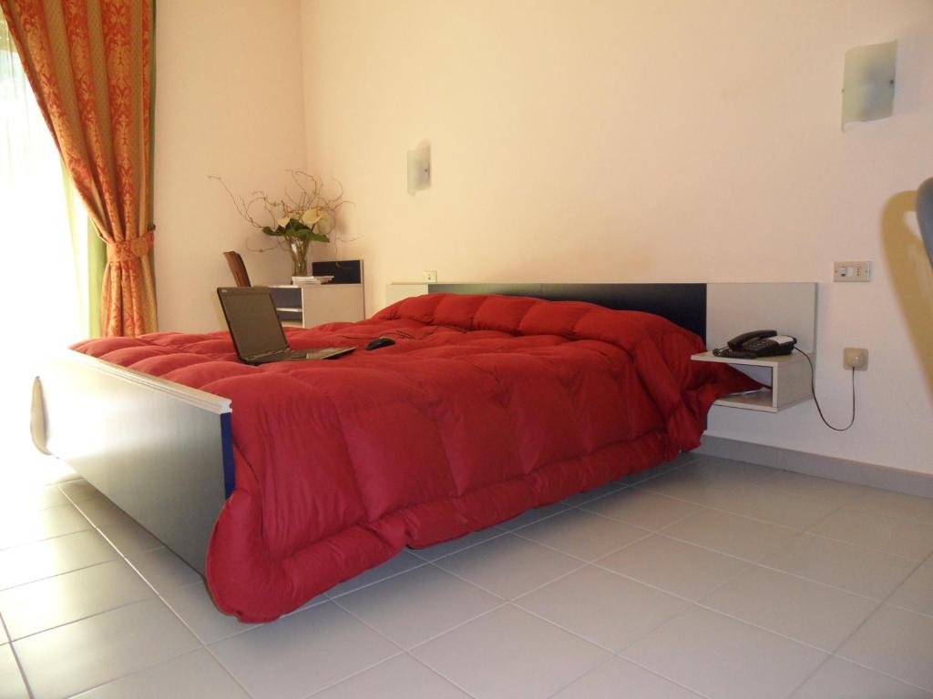 Postel nebo postele na pokoji v ubytování Hotel Villa Giusy