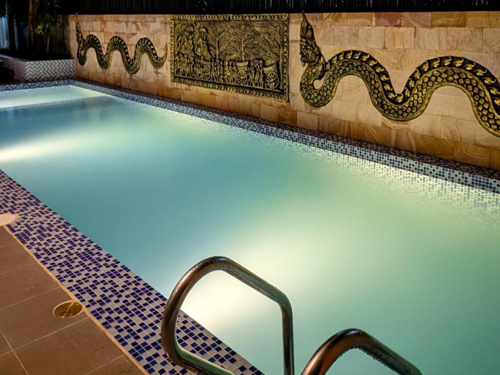 a swimming pool with a light in the middle at Nina Angkor Residences in Siem Reap