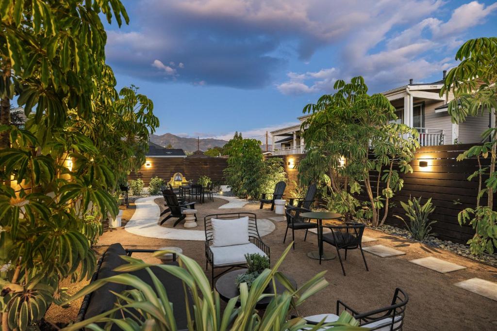 a patio with tables and chairs and trees at Casa Castillo - Boutique Suites in Downtown Santa Barbara in Santa Barbara