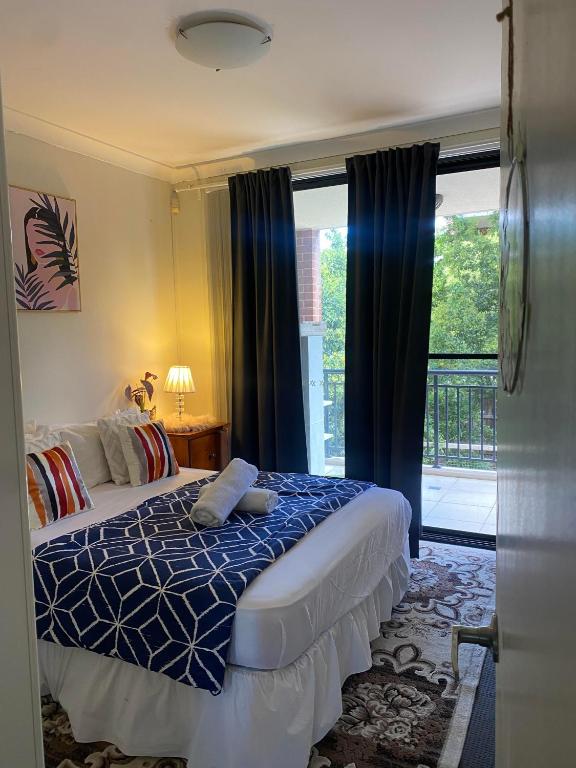 a bedroom with a bed and a large window at Platform One Guildford in Guildford