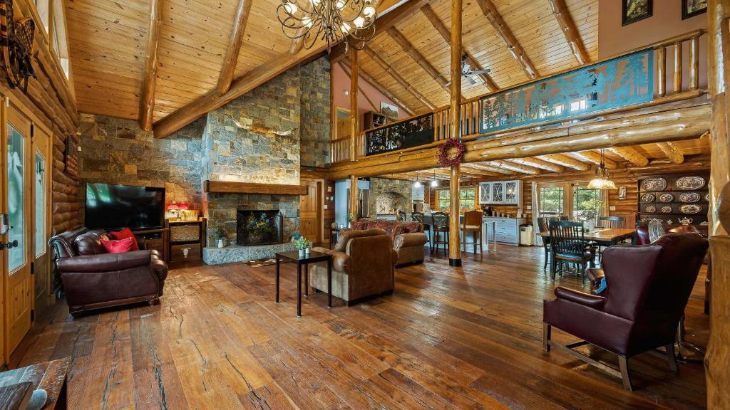 Bigwood Cabin Retreat Hot Tub Game Room Firepit Lounge Private Yard في Long Pond: غرفة معيشة كبيرة مع موقد حجري كبير