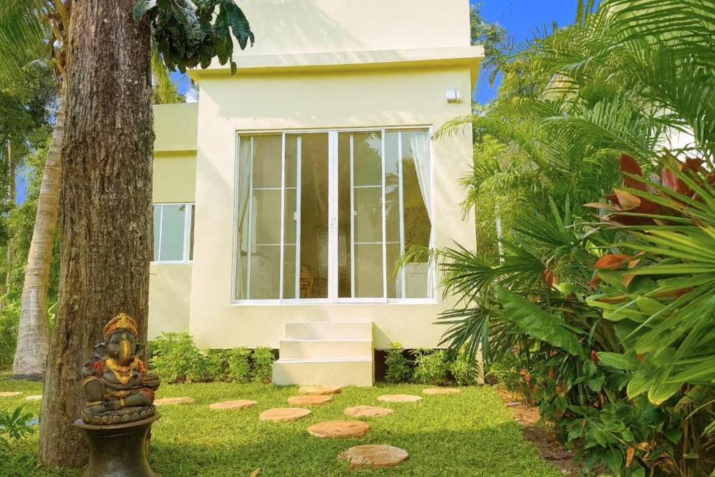 a house with a statue in front of it at Bright Sanctuary in Ko Phangan