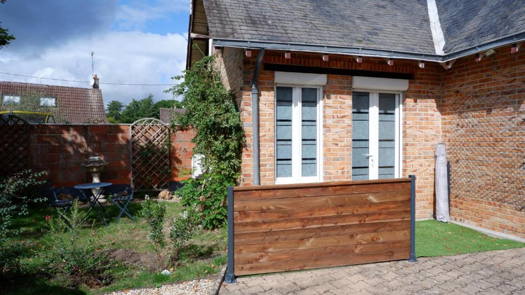 a house with a wooden gate in front of it at A l'étoile du soir in Nançay
