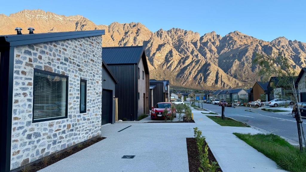a street in a town with mountains in the background at Luxurious Stay with Mountain Views in Queenstown