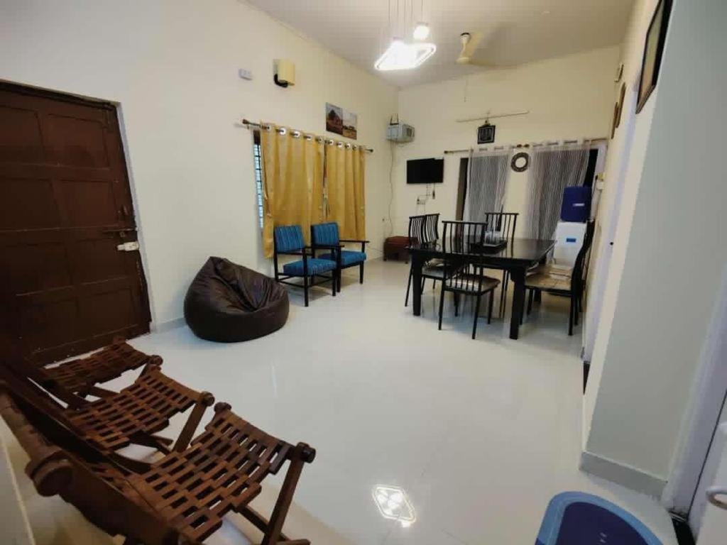 a living room with a table and chairs at Zivo Stays, Heritage Apartments, Rethibowli in Hyderabad