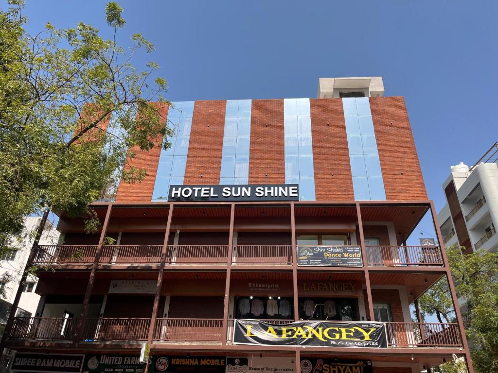 a hotel sun shine sign on the side of a building at Hotel Sun Shine in Jāmb