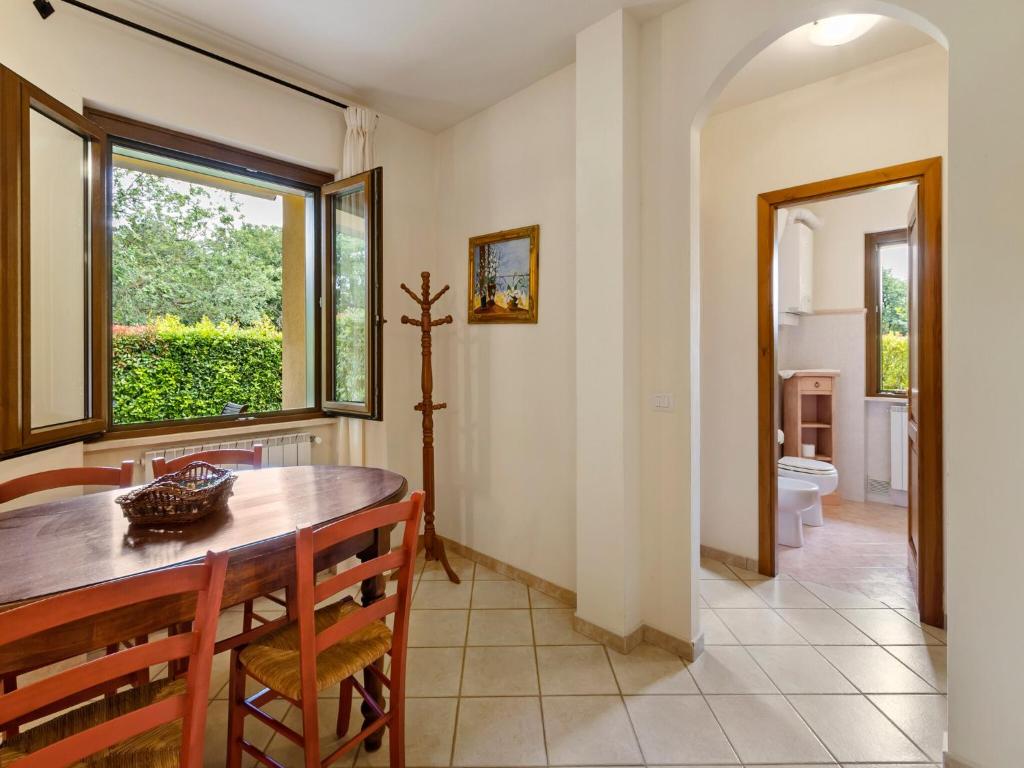 a dining room with a table and a window at Gorgeous Holiday Home in Sorano with Swimming Pool in Sorano