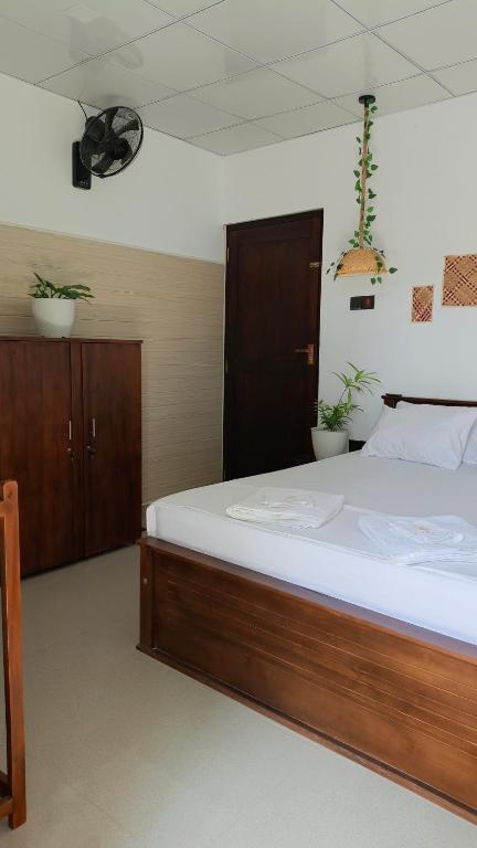a bedroom with a large bed with white sheets at Junction 14 Villa in Dikwella North
