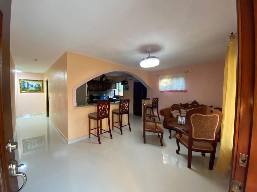 a dining room and living room with a table and chairs at La Ureña House in La Ureña