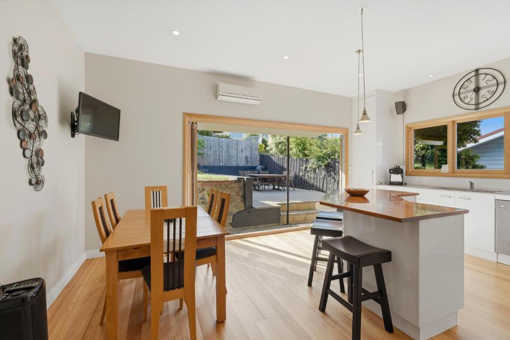 a kitchen and dining room with a table and chairs at Poets View - 3 Bedroom House in West Hobart