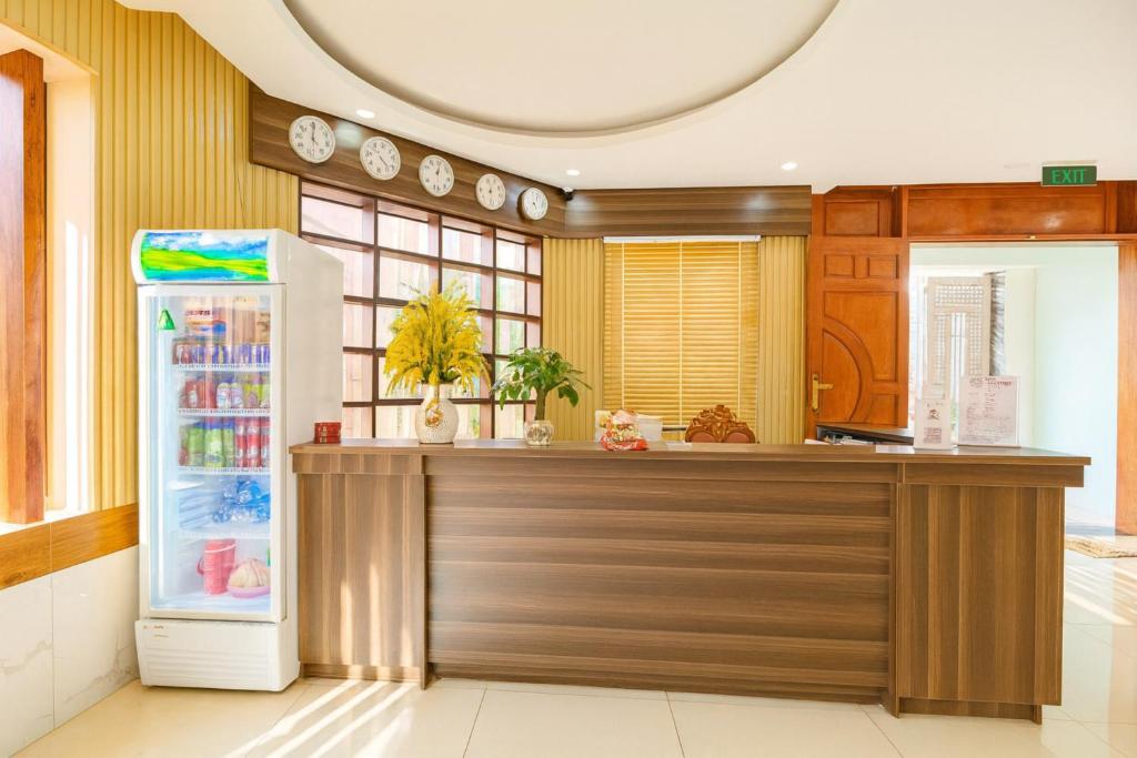 a kitchen with a refrigerator and a counter at Hưng Phú Hotel HCM in Ho Chi Minh City
